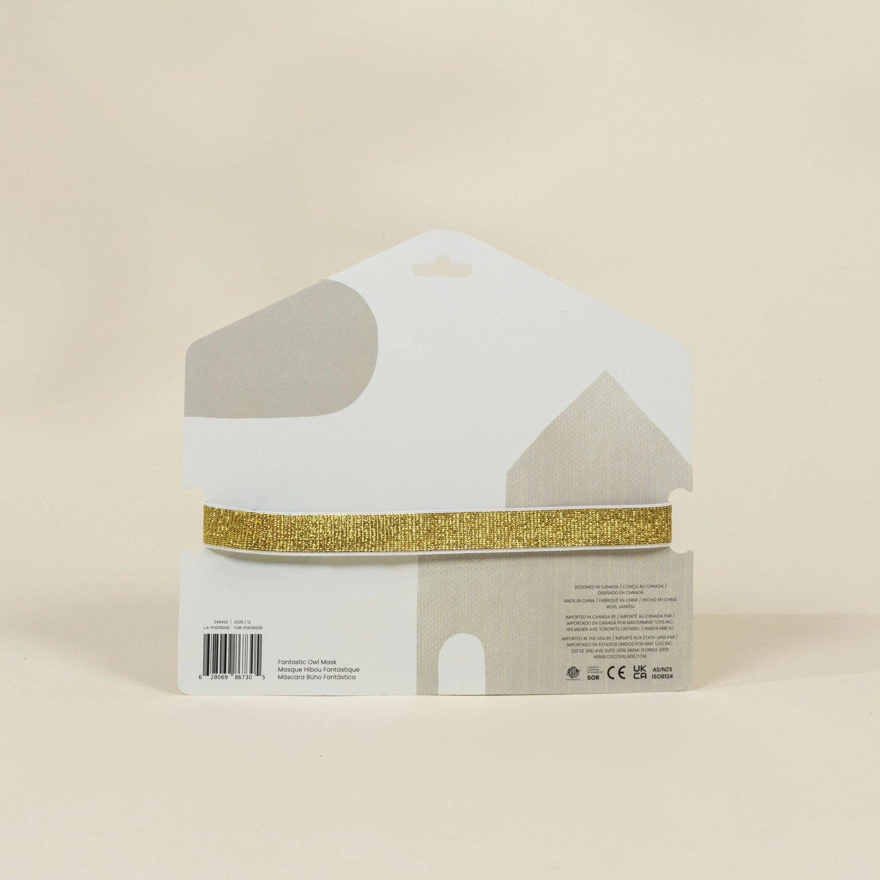 Product packaging with gold ribbon on a beige background