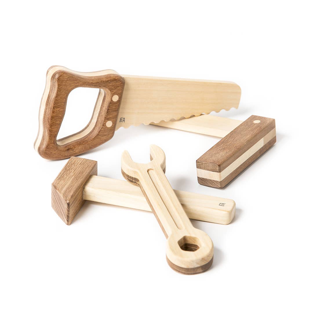 Set of wooden tools including a axe, wrench, and hammer on a white background