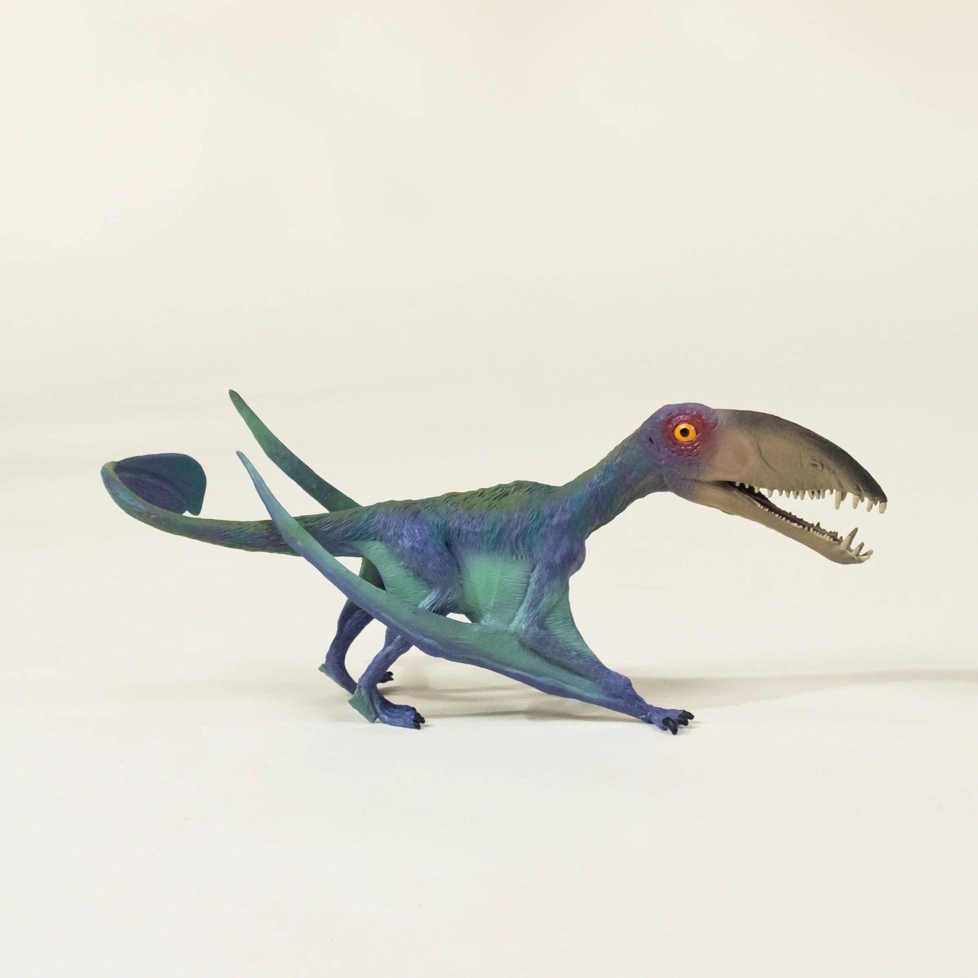 Toy dinosaur model on a beige background