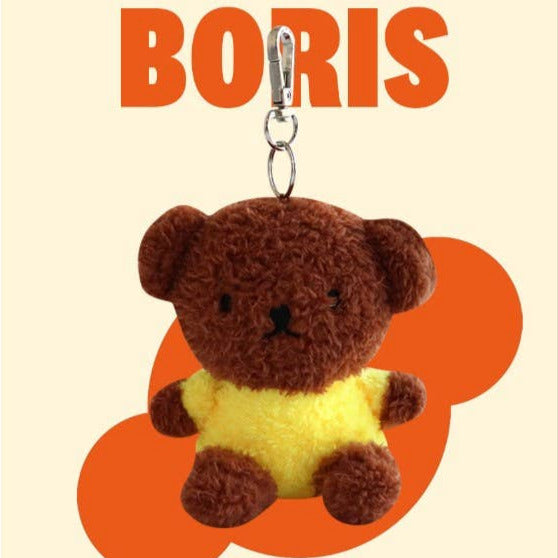Plush bear keychain with 'BORIS' text on a beige background