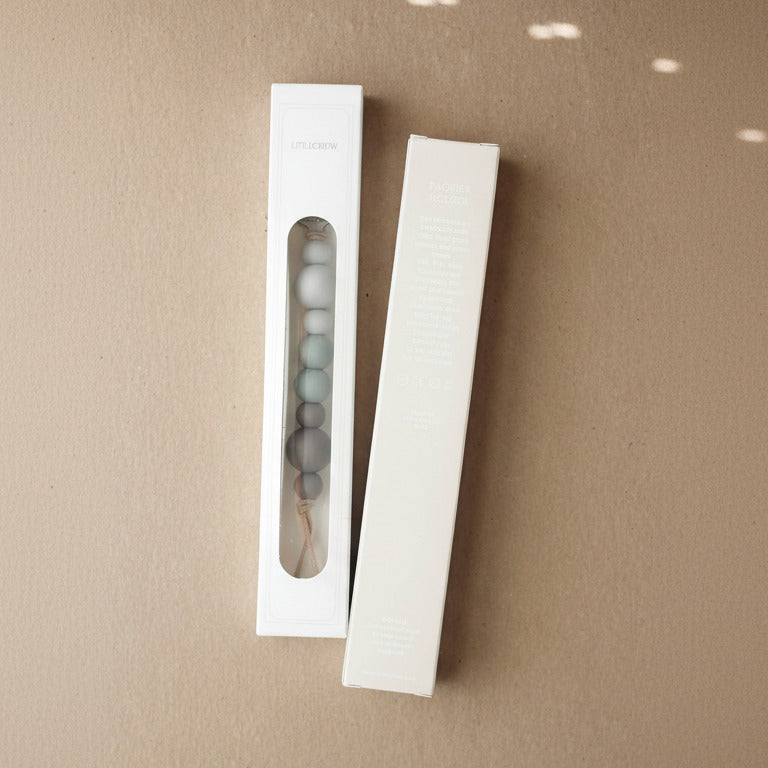 Two white packaging boxes with a clear window on a brown background