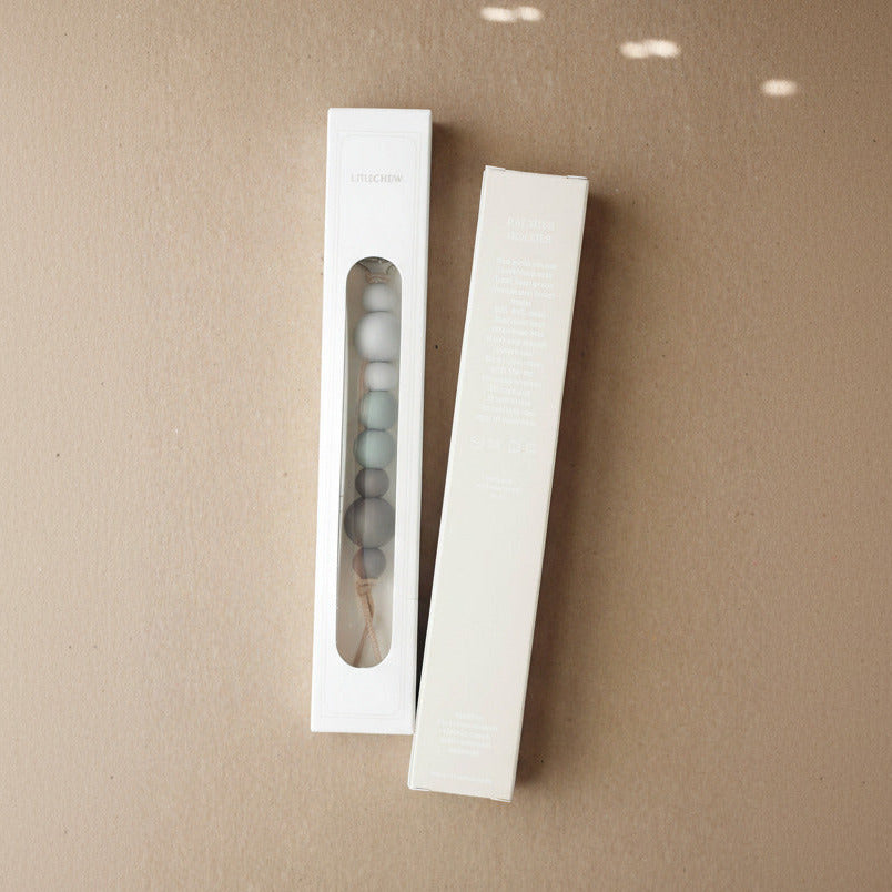 Two white packaging boxes with a clear window on a brown background