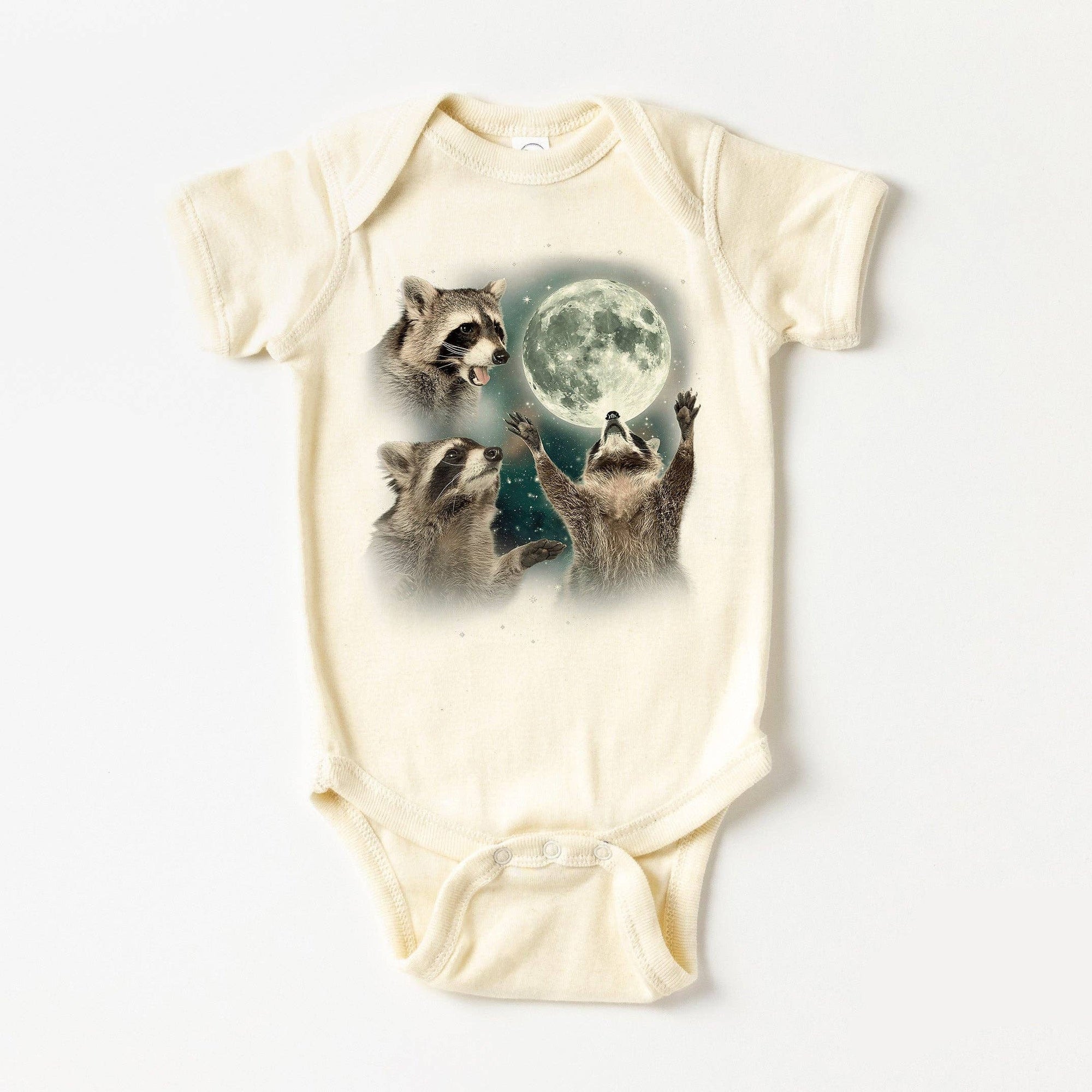 Baby onesie with raccoon design and 'Blue Giraffe' branding on a white background