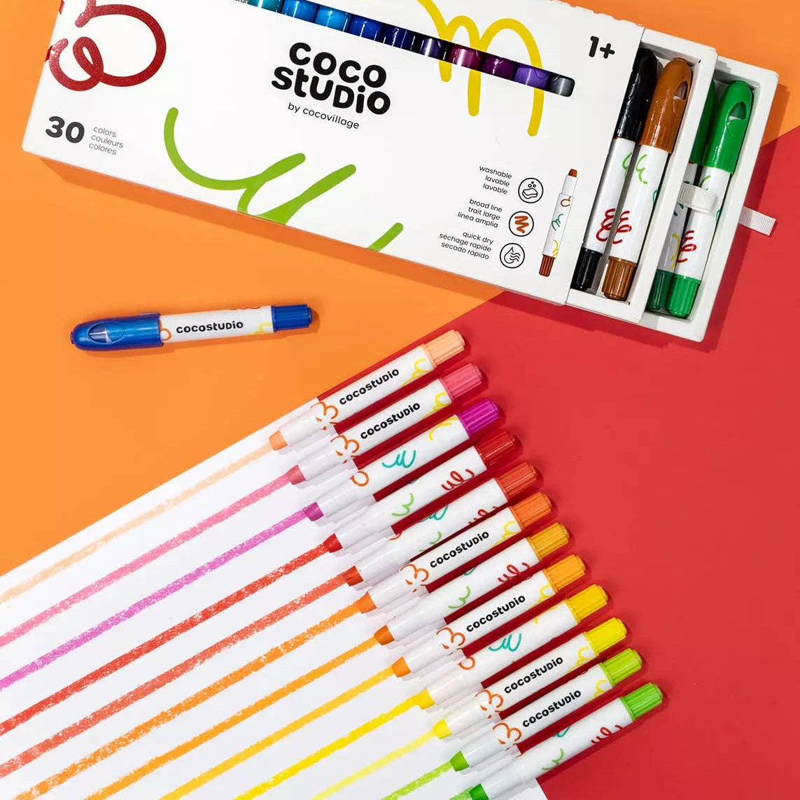 Coco Studio markers with packaging on an orange and red background