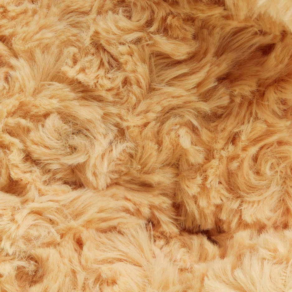Close-up of a beige, fluffy fabric texture