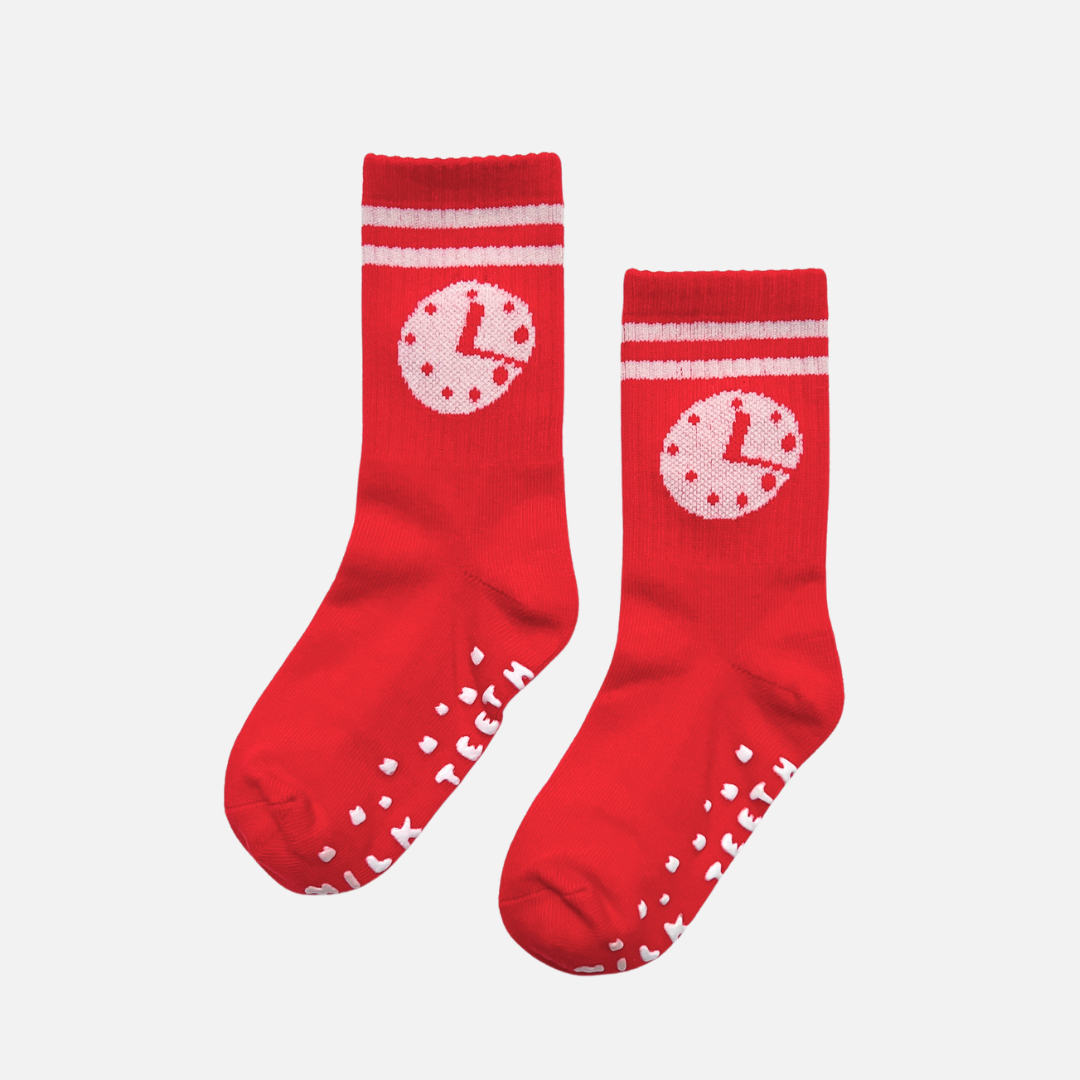 Red socks with white patterns on a light gray background