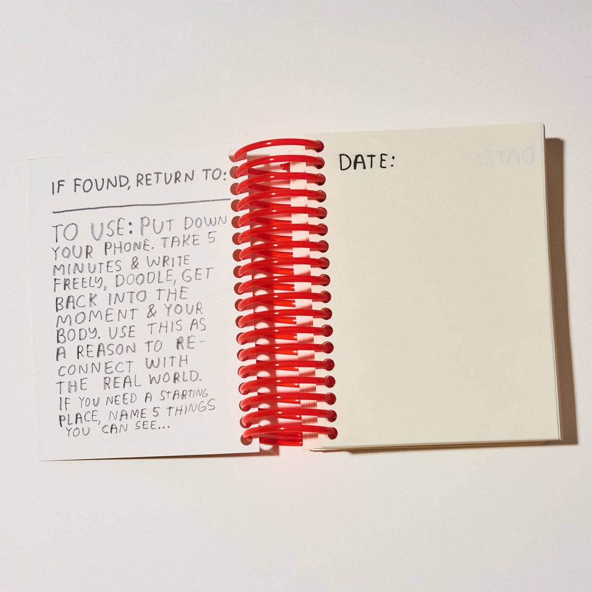 Notebook with a red spiral on a white background