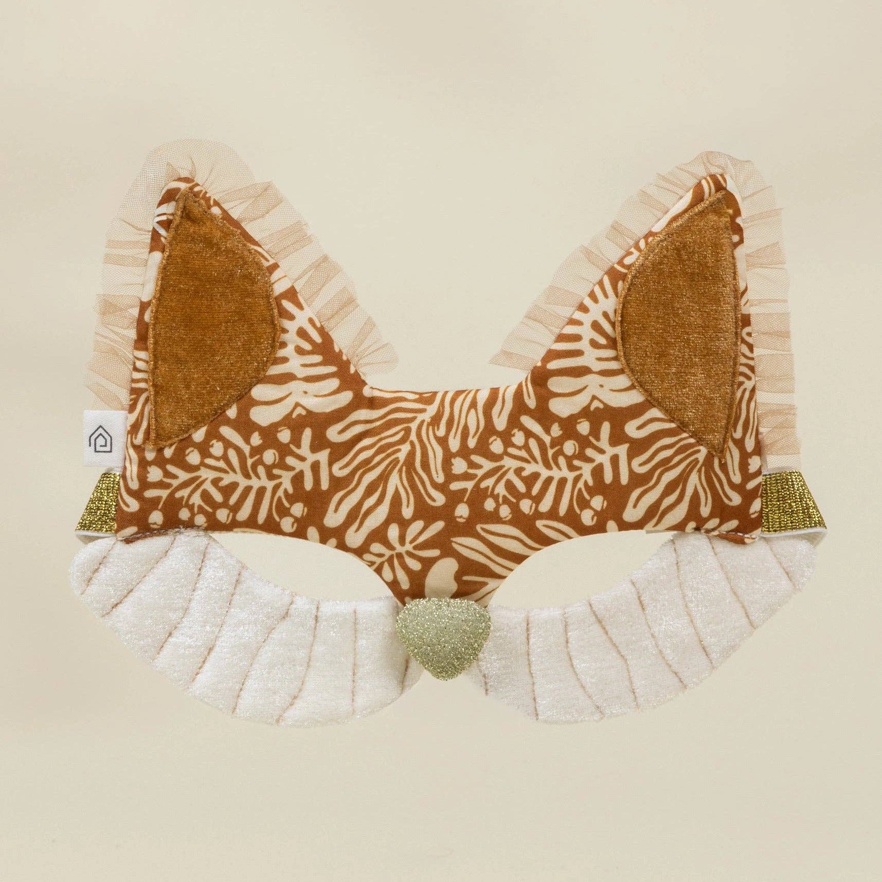 Fabric bow with brown pattern and white ruffles on a beige background