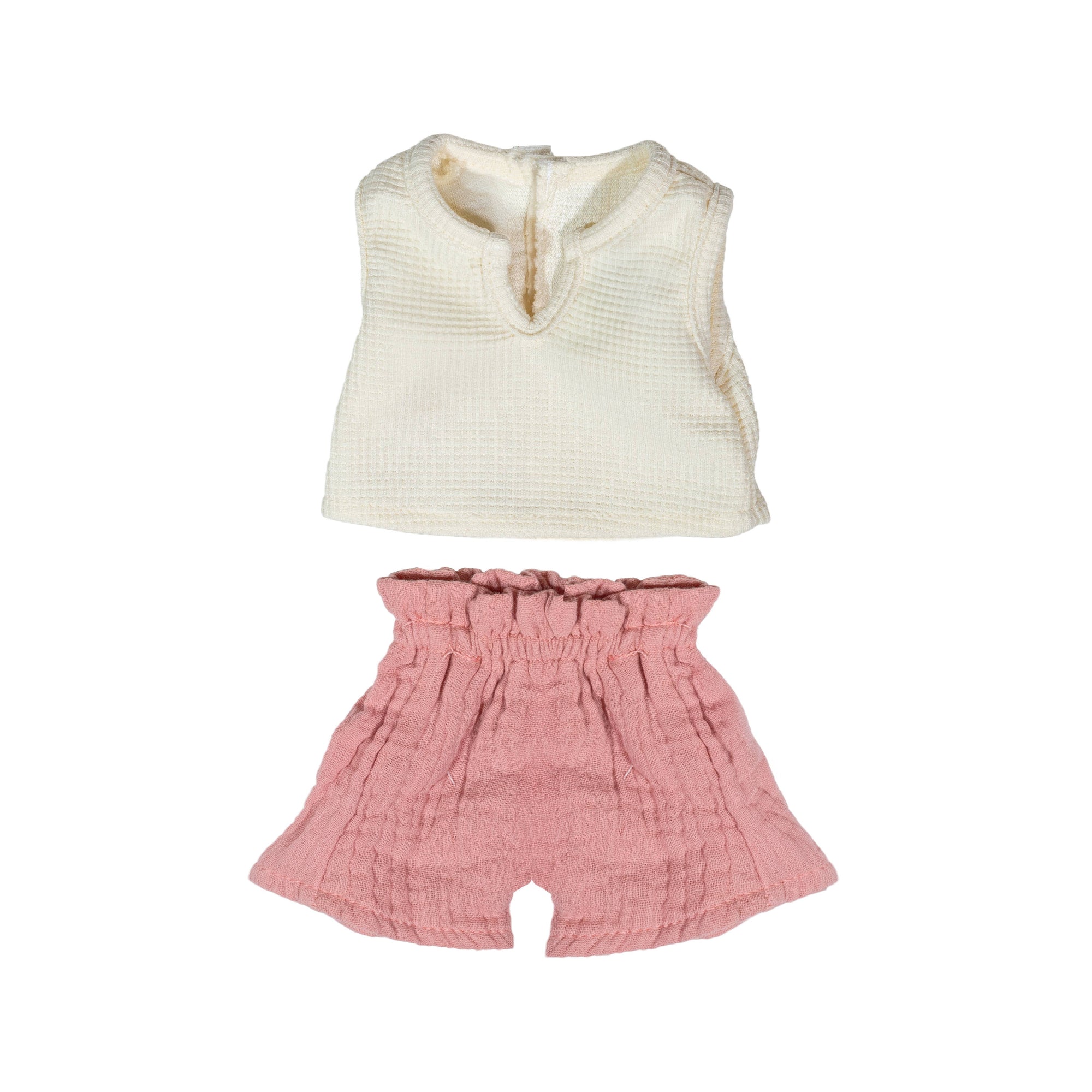 White sleeveless doll top and pink shorts on a white background