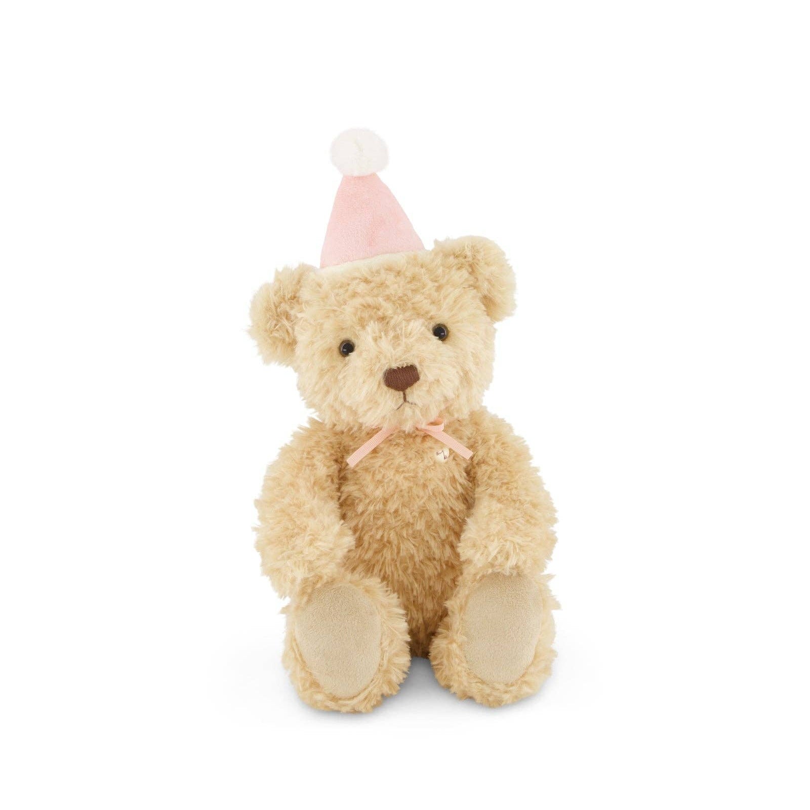 Plush teddy bear wearing a pink party hat on a white background