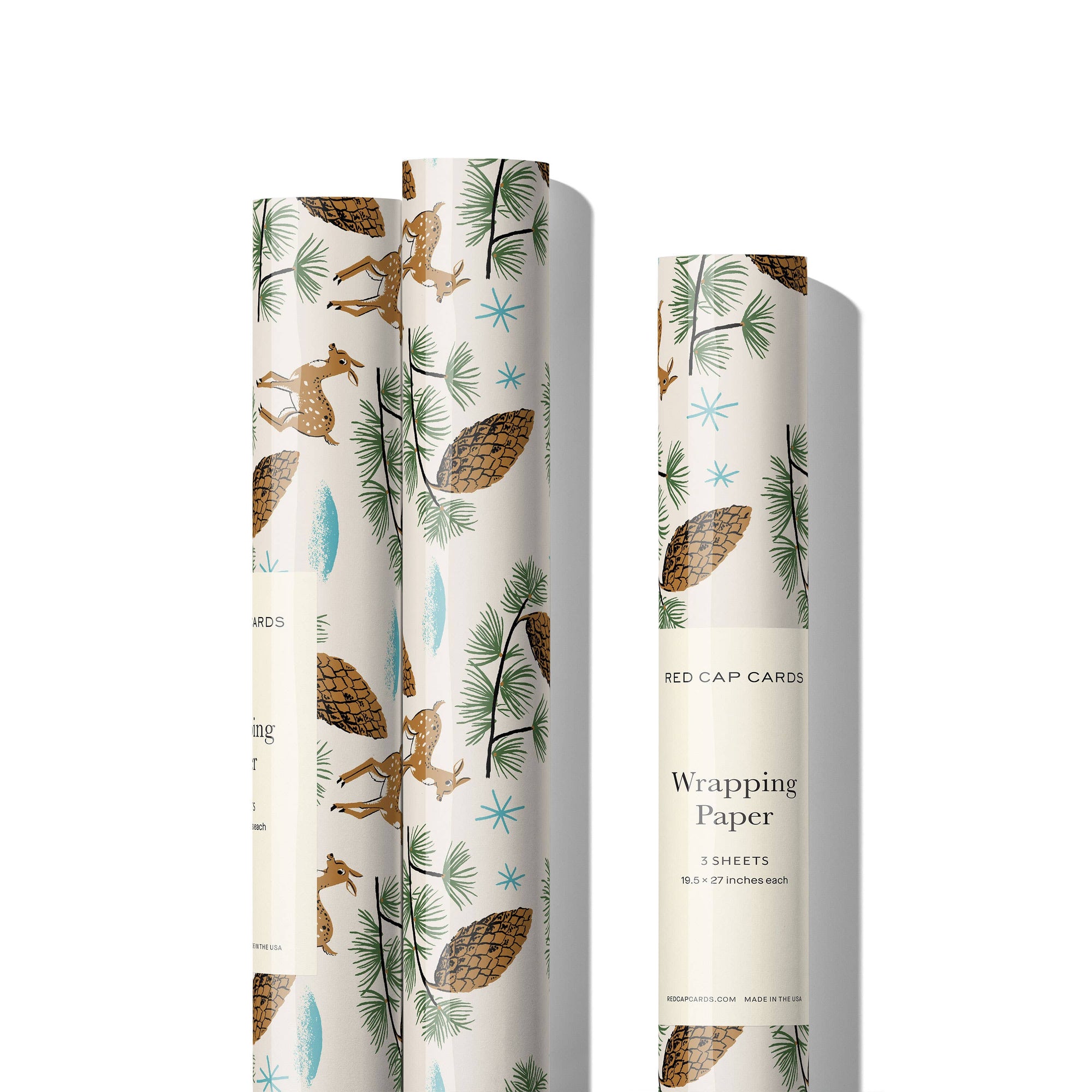 Three rolls of wrapping paper with nature-themed designs on a white background.