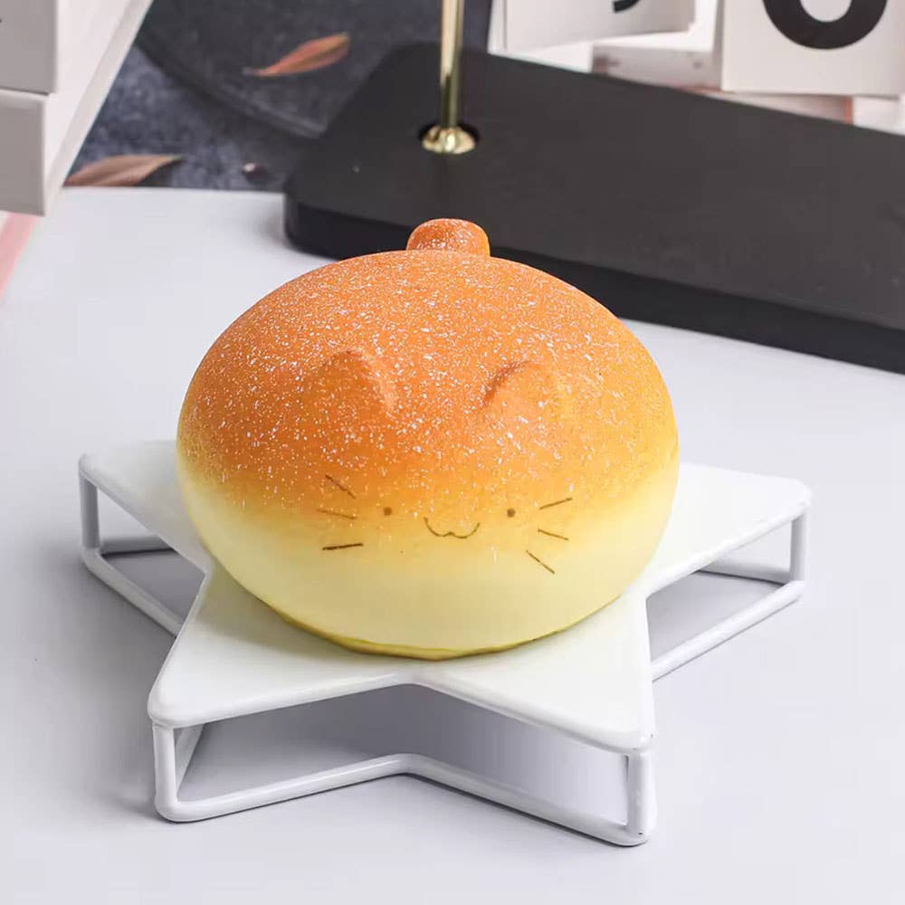 Cat-shaped bread light on a white stand with a blurred background