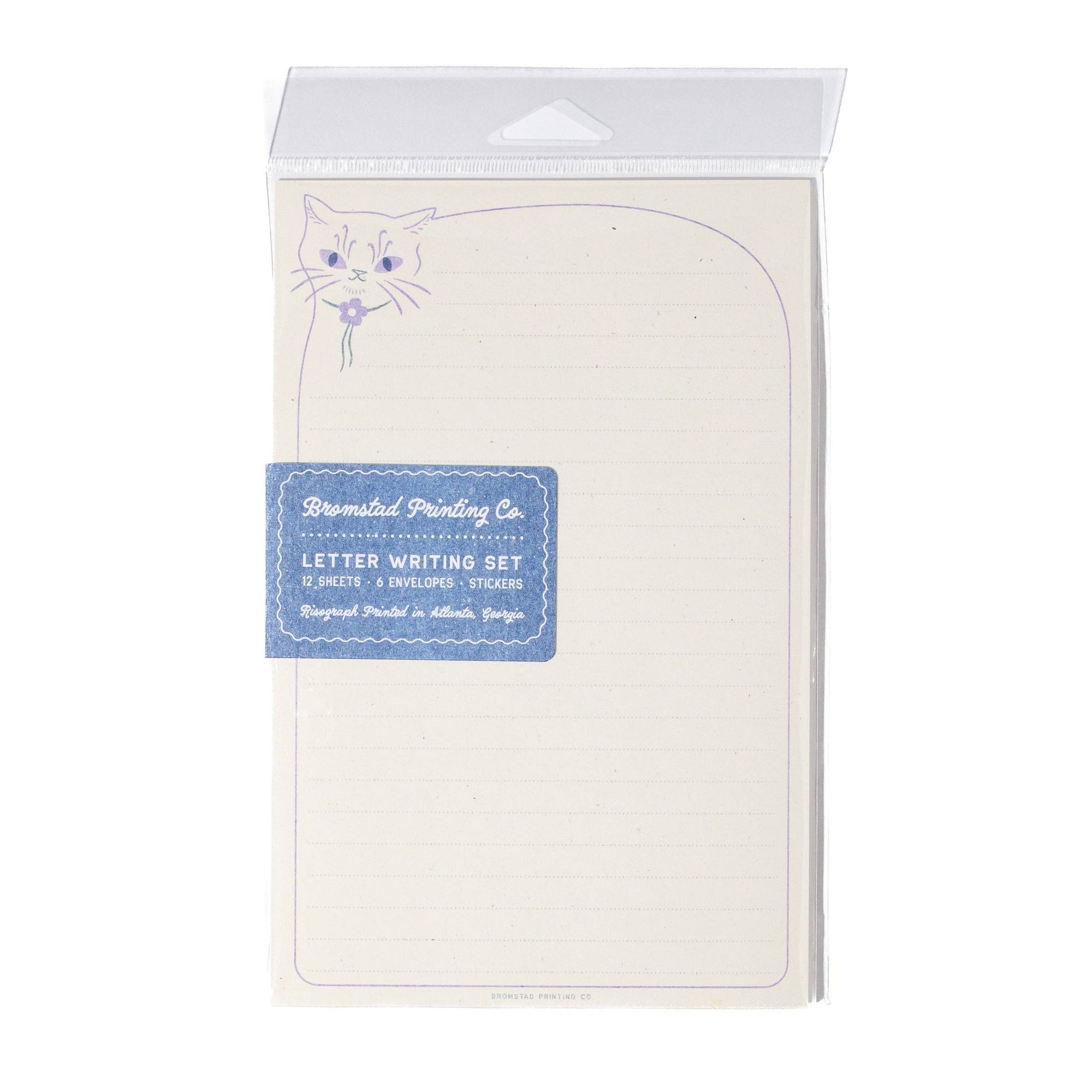 A packaged letter writing set by Ruminated Printing Co., featuring cream-colored lined paper with a small purple cat illustration and a blue label on the front.