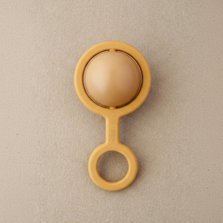 Beige baby teether on a beige background