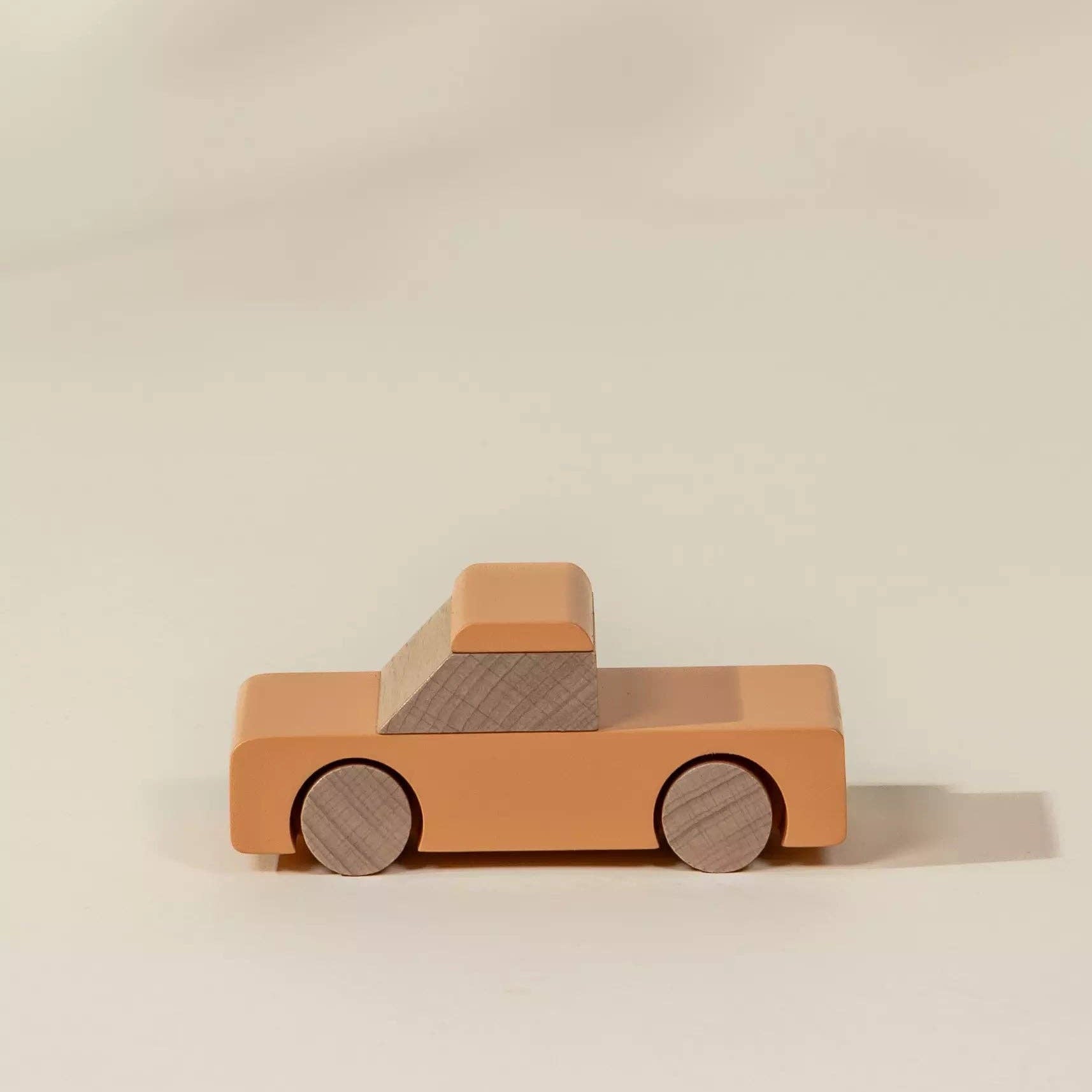 Wooden toy truck on a beige background
