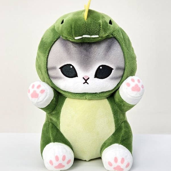 Plush toy of a cat in a green dinosaur costume on a white background
