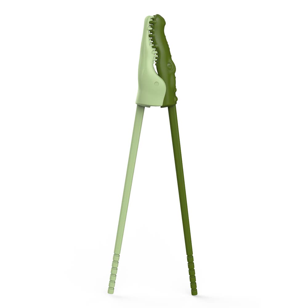 Green tongs with a crocodile-like head on a white background