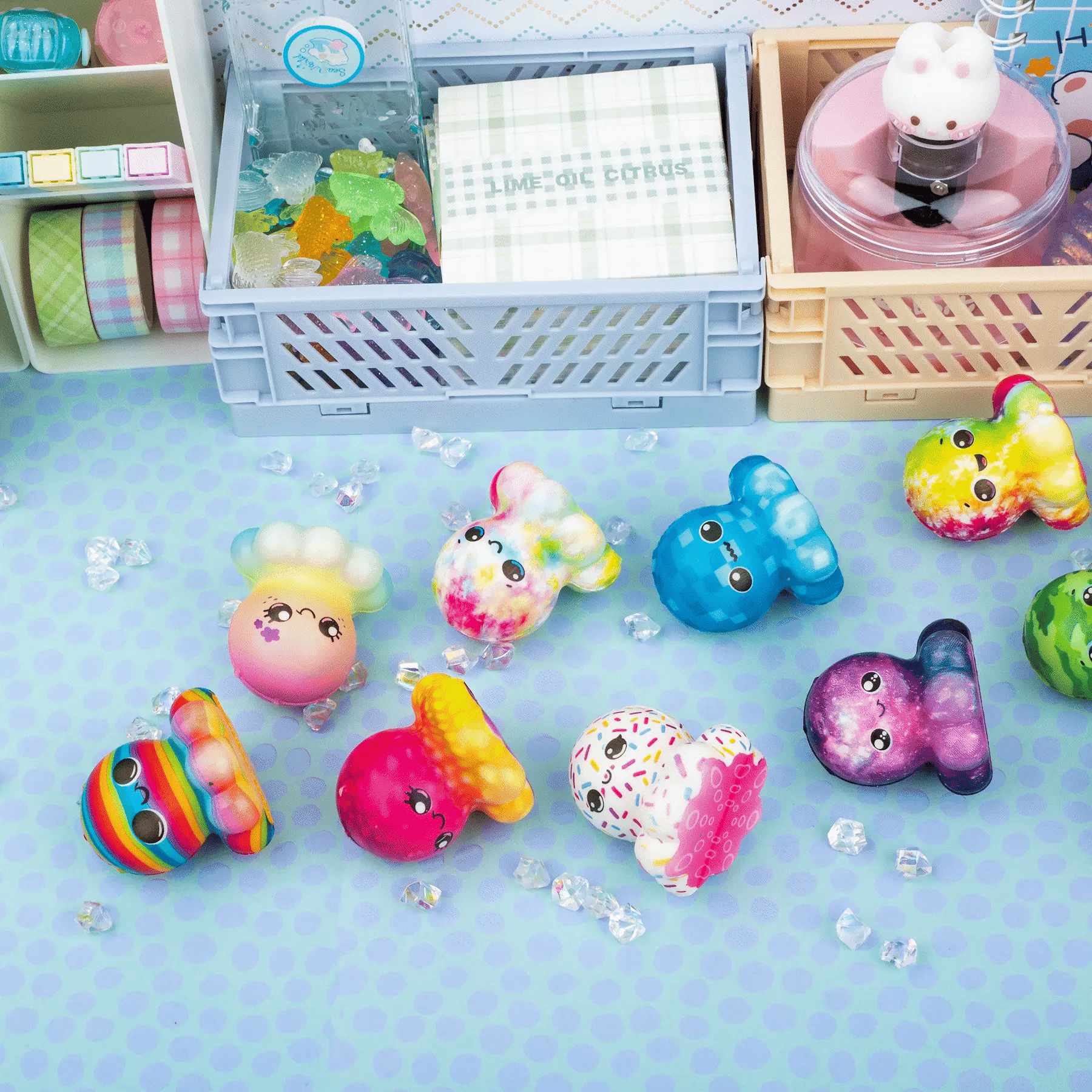 Colorful cartoon-style figurines on a light blue surface with storage bins in the background.
