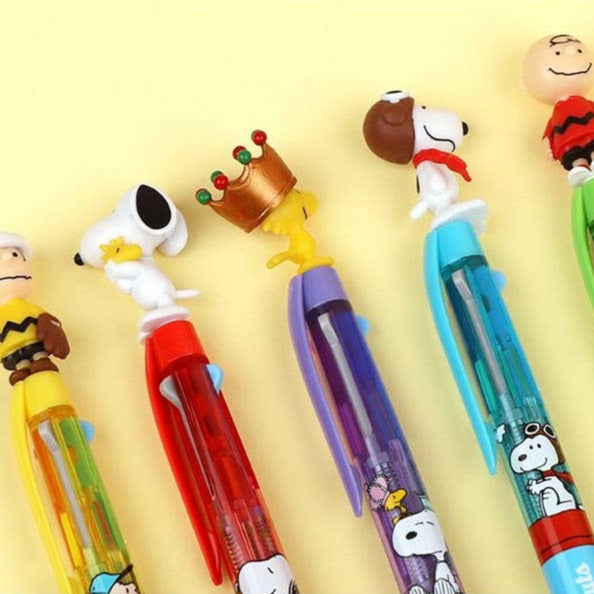 Set of colorful pens with cartoon character ends on a yellow background