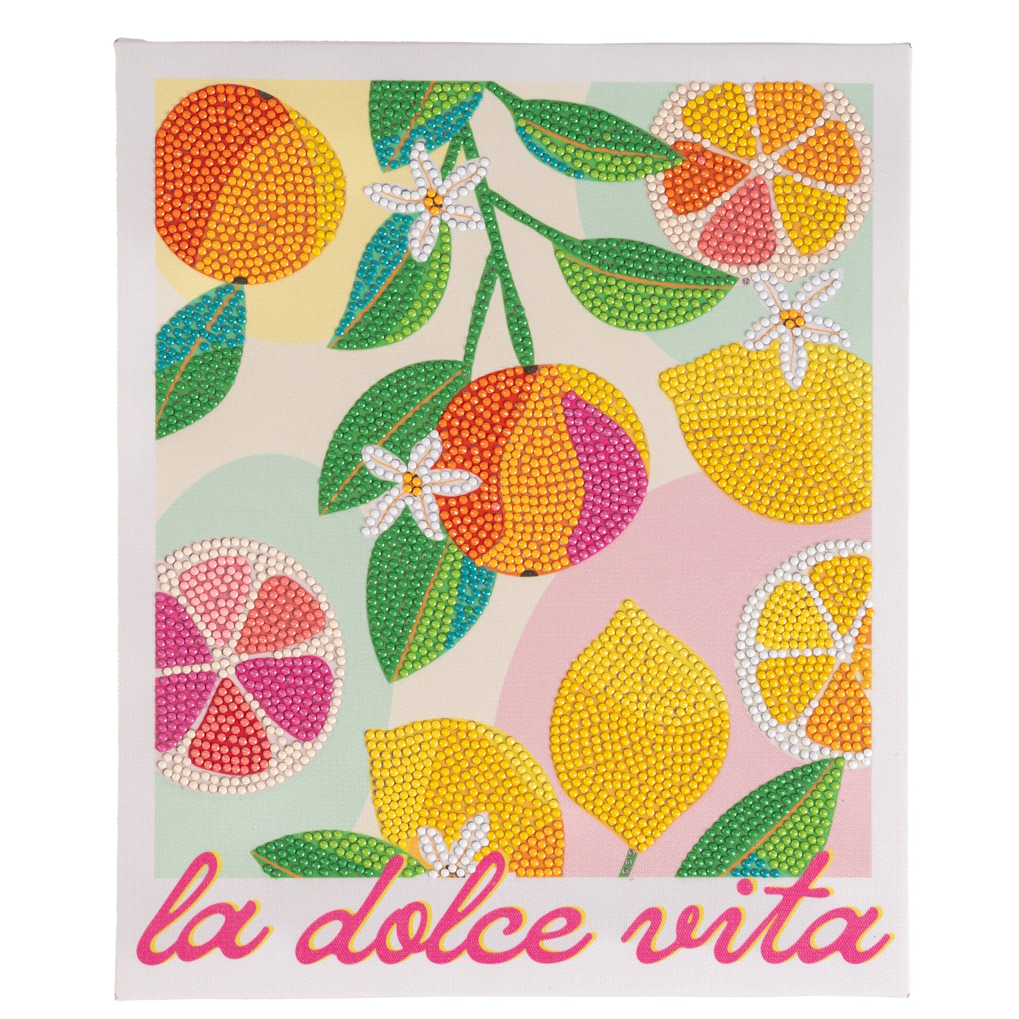 Decorative towel with colorful fruit design and 'la dolce vita' text on a light background
