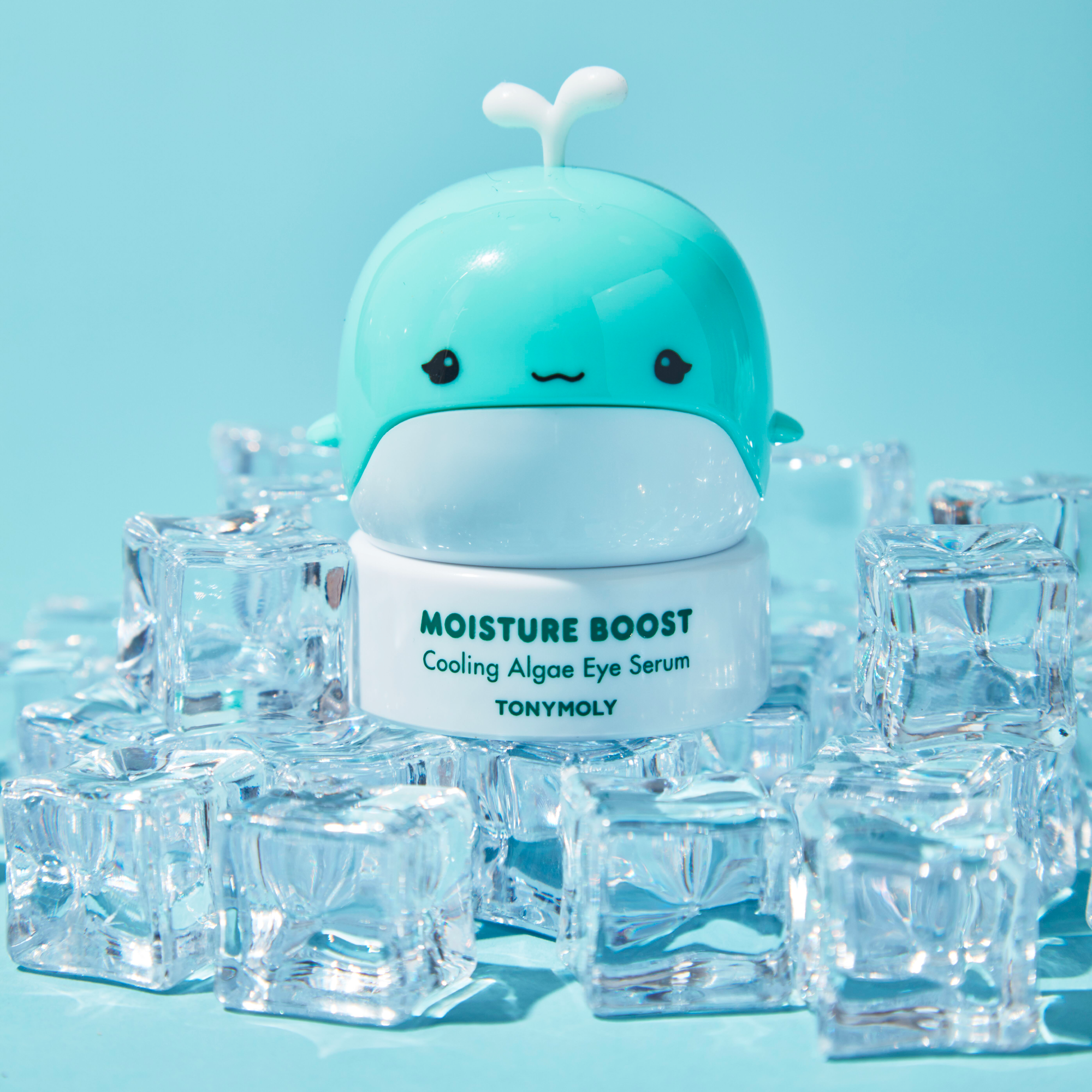 TONYMOLY Moisture Boost Cooling Algae Eye Serum with a whale-shaped container on ice cubes against a blue background