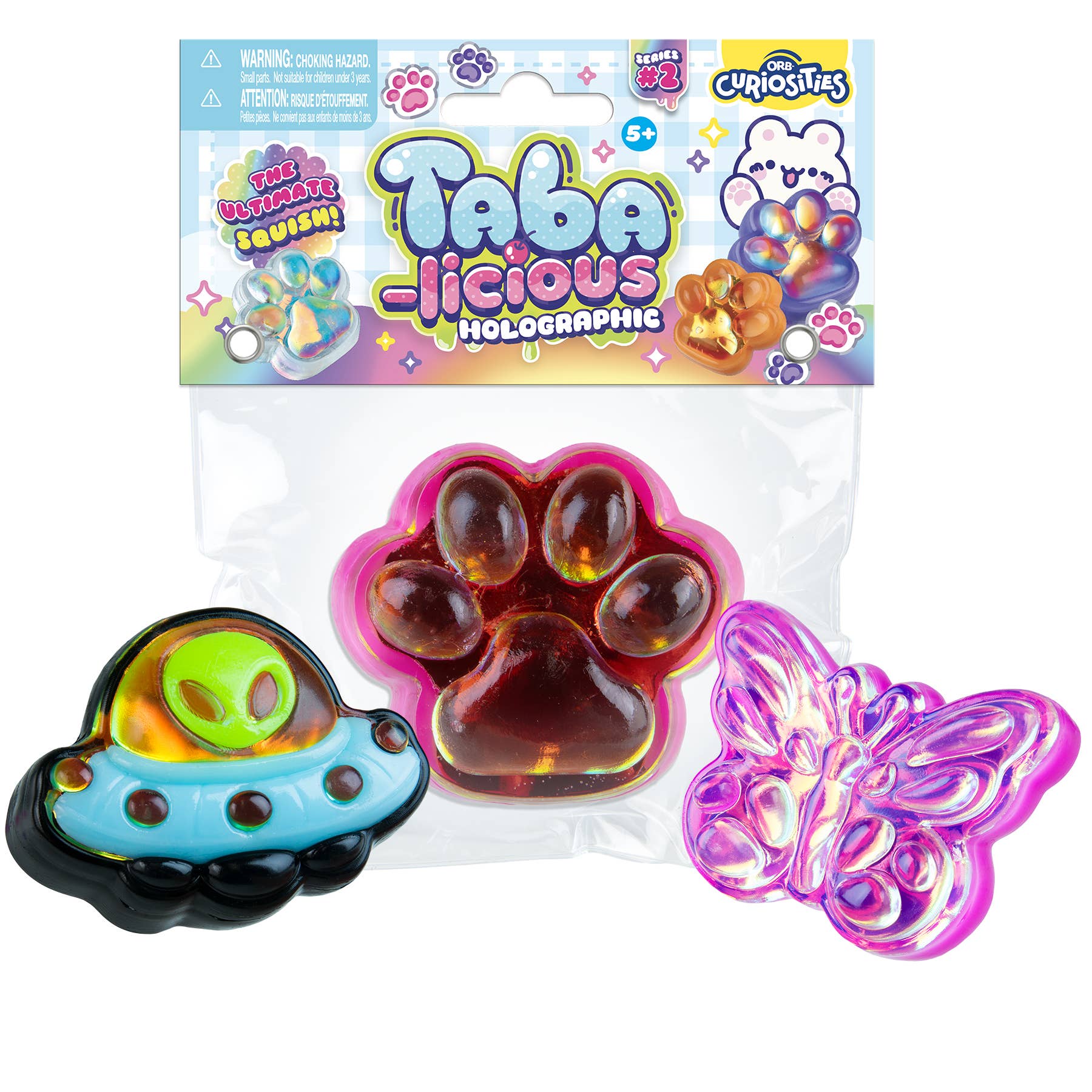Packaged toy set with Taba-licious branding featuring a paw-shaped toy, UFO-shaped toy, and butterfly-shaped toy.