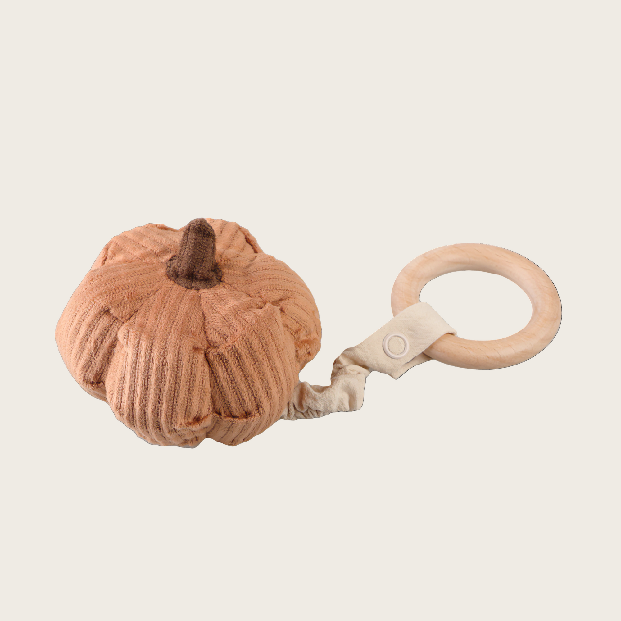 Pumpkin-shaped teething ring with wooden ring on a white background