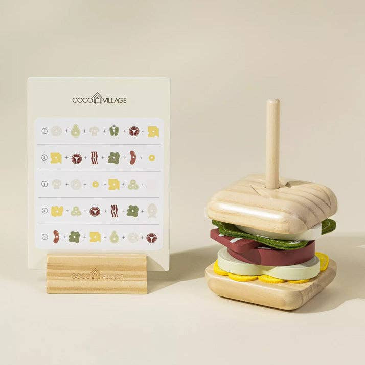Wooden toy hamburger with a stand on a beige background