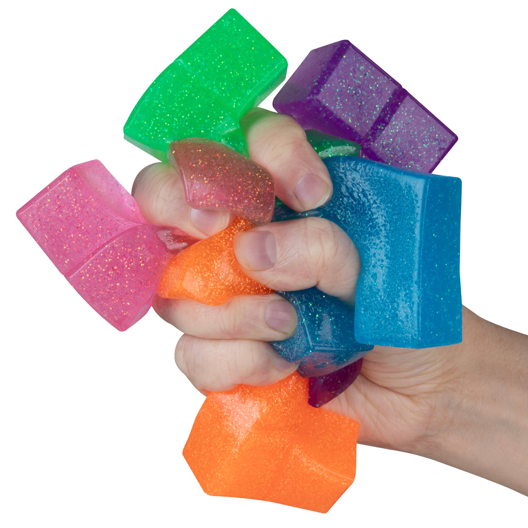 Hand squeezing colorful foam cubes on a white background