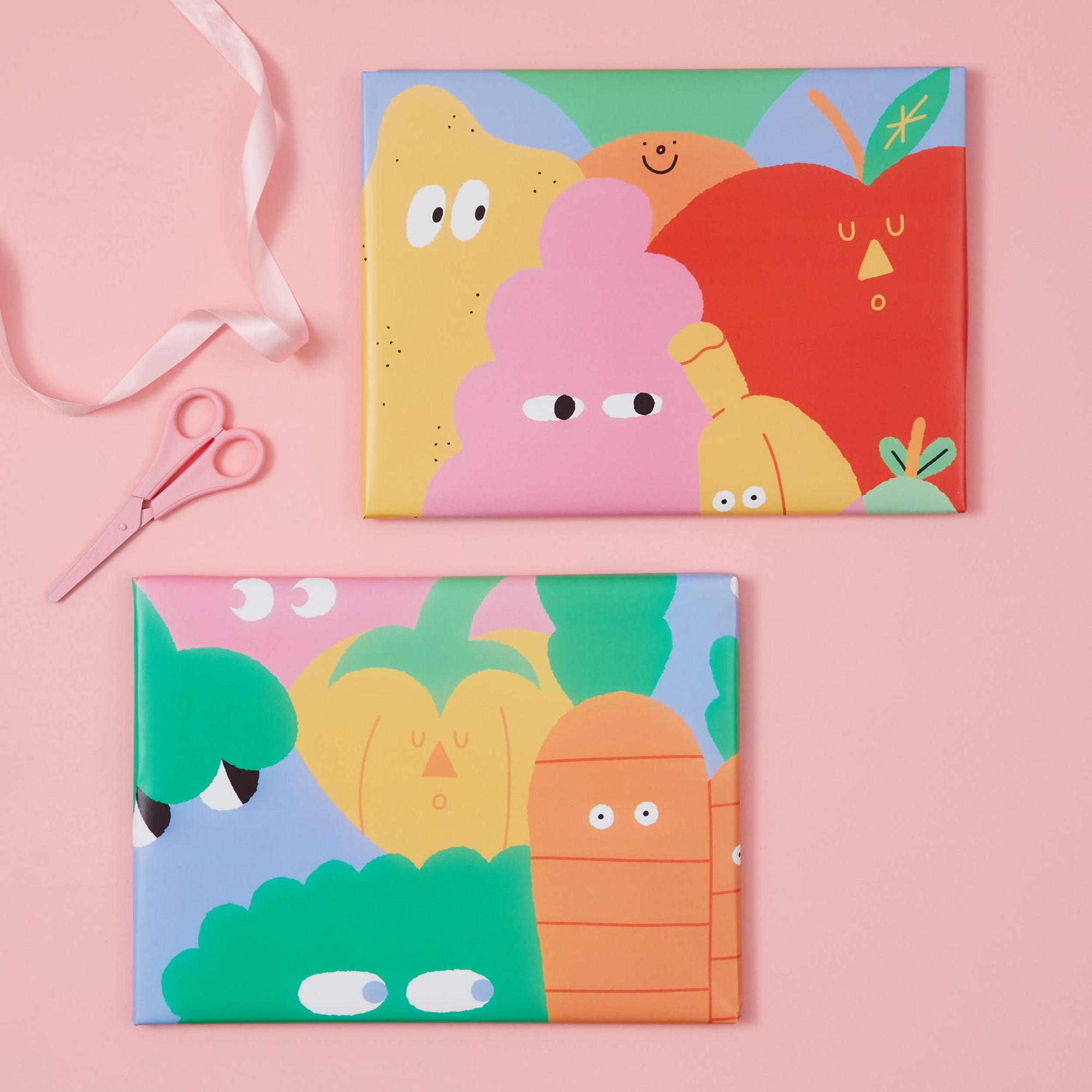 Two colorful greeting cards with cartoonish designs on a pink background.