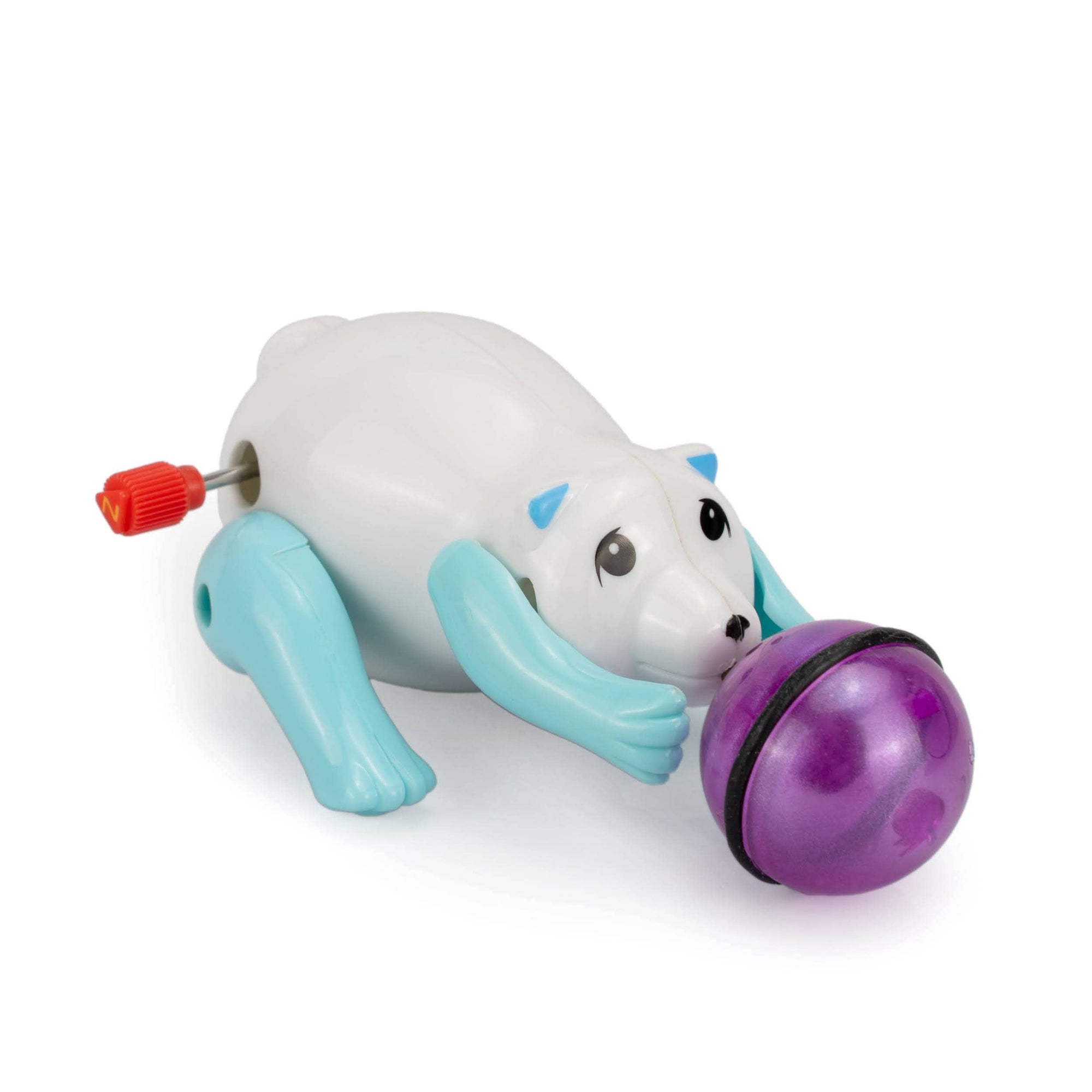 Toy polar bear with a purple ball on a white background
