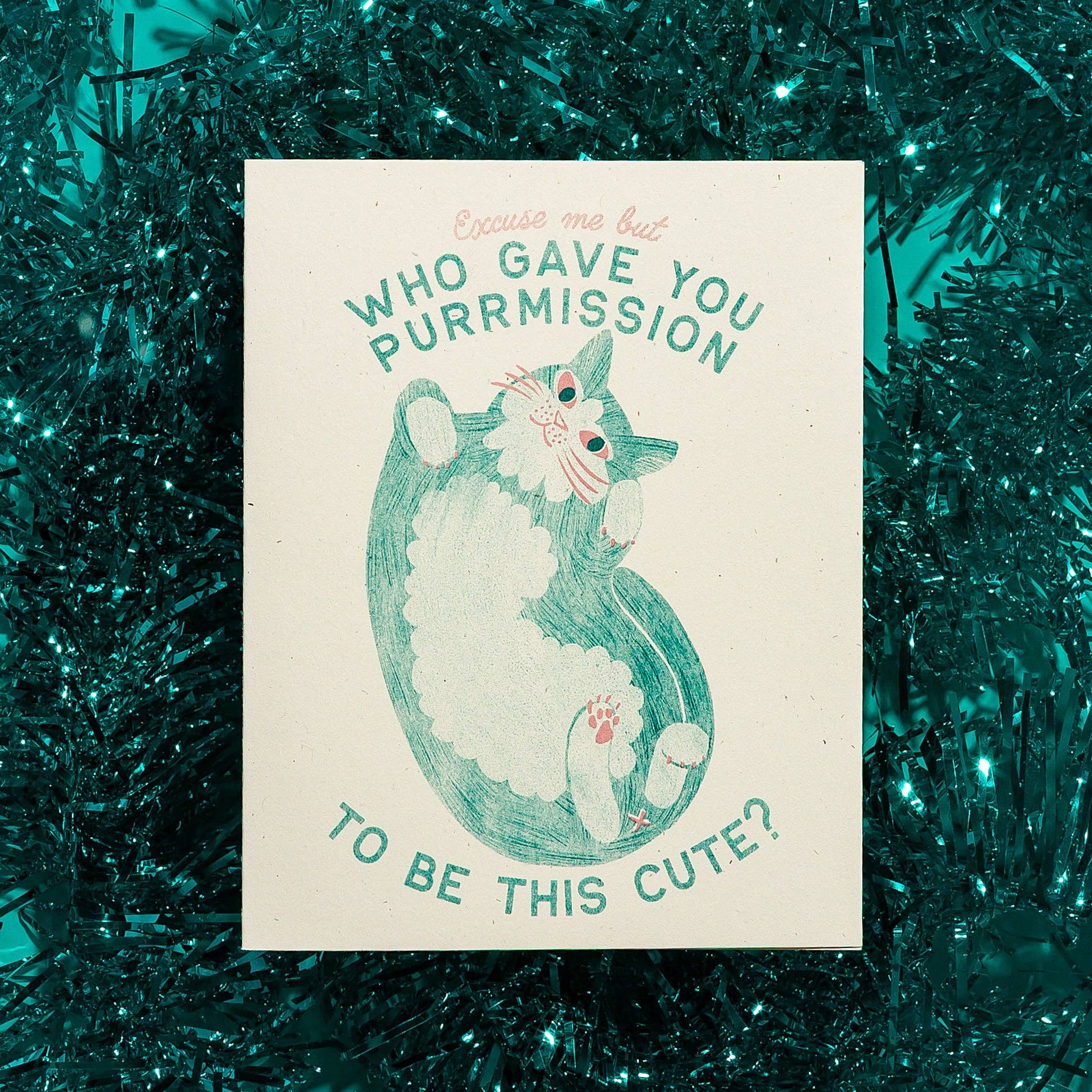 Card with a cat illustration and text on a green tinsel background