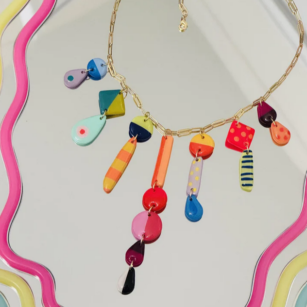 Colorful beaded necklace on a decorative background