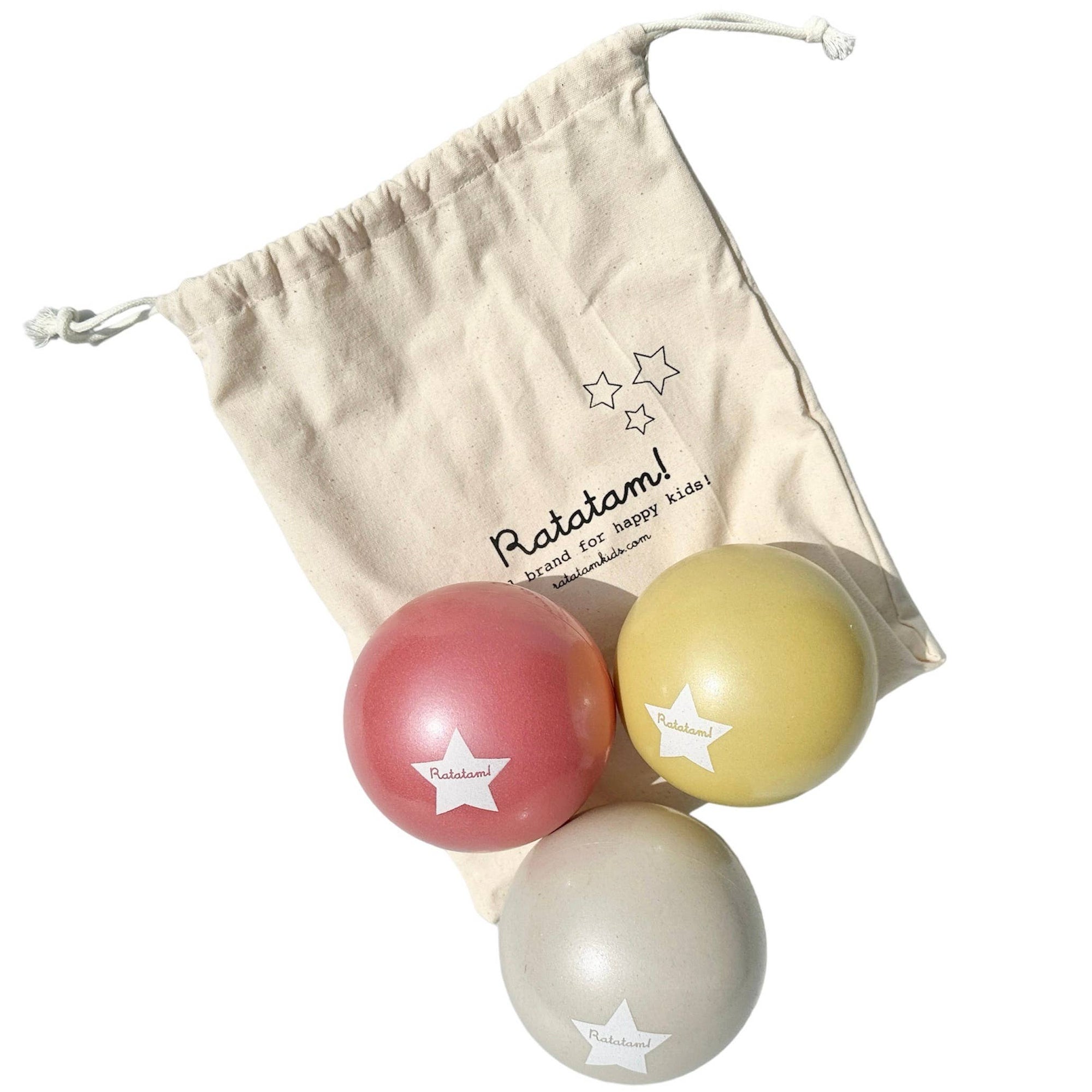 Three colorful balls with star patterns on a beige drawstring bag featuring the brand 'RataTam'.
