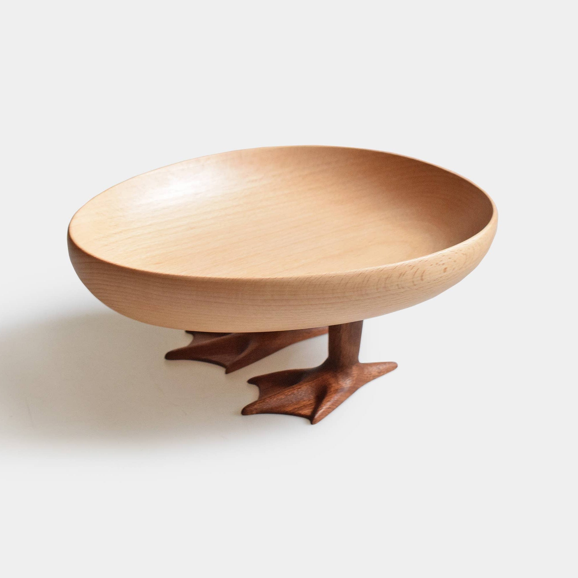 Wooden bowl with bird feet design on a white background