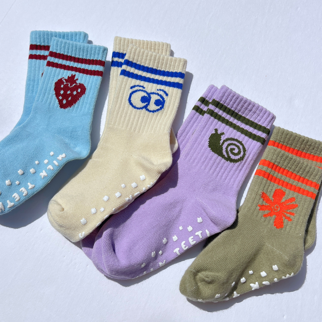 Five colorful socks with various designs on a light gray background