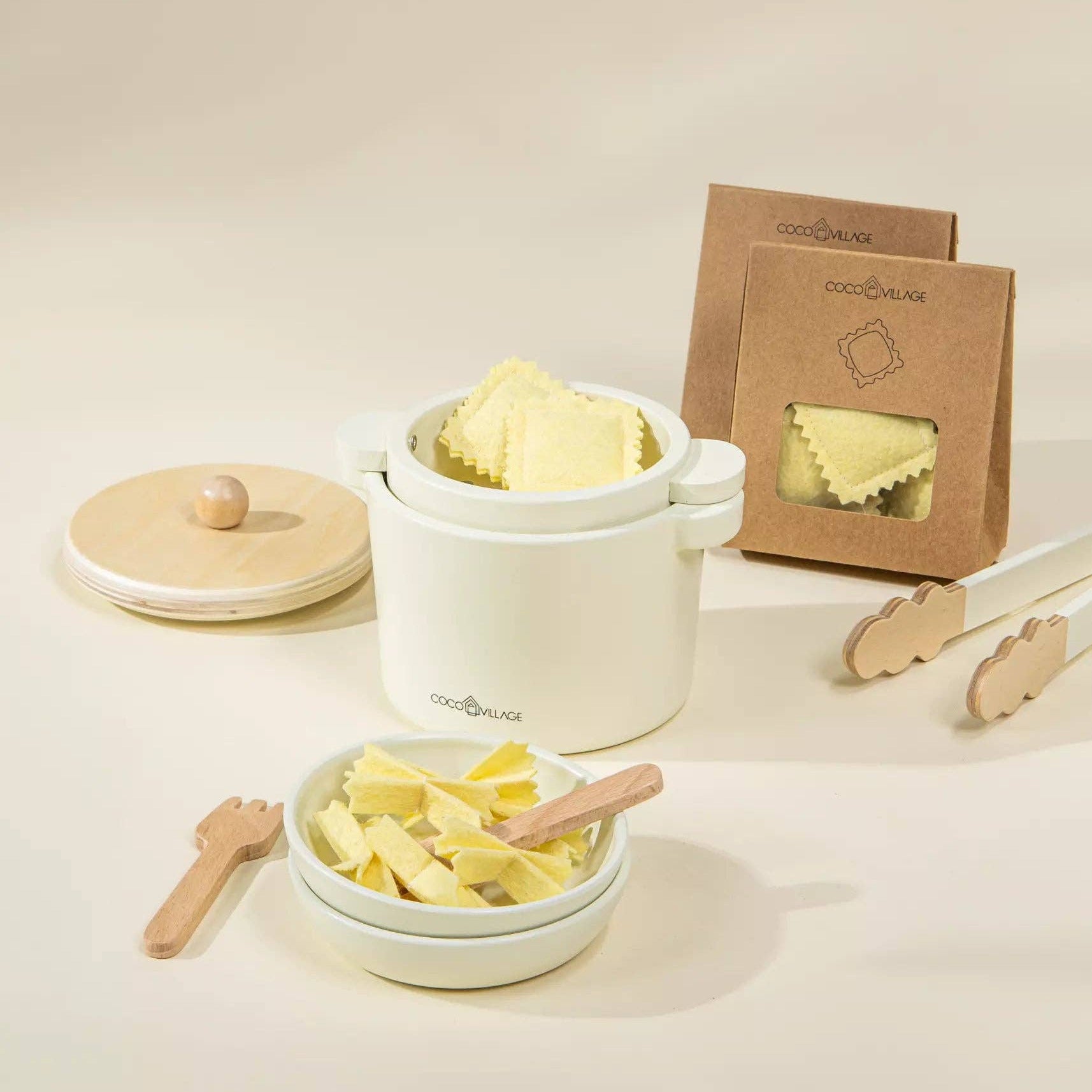 Set of white containers with pasta and wooden utensils on a light background