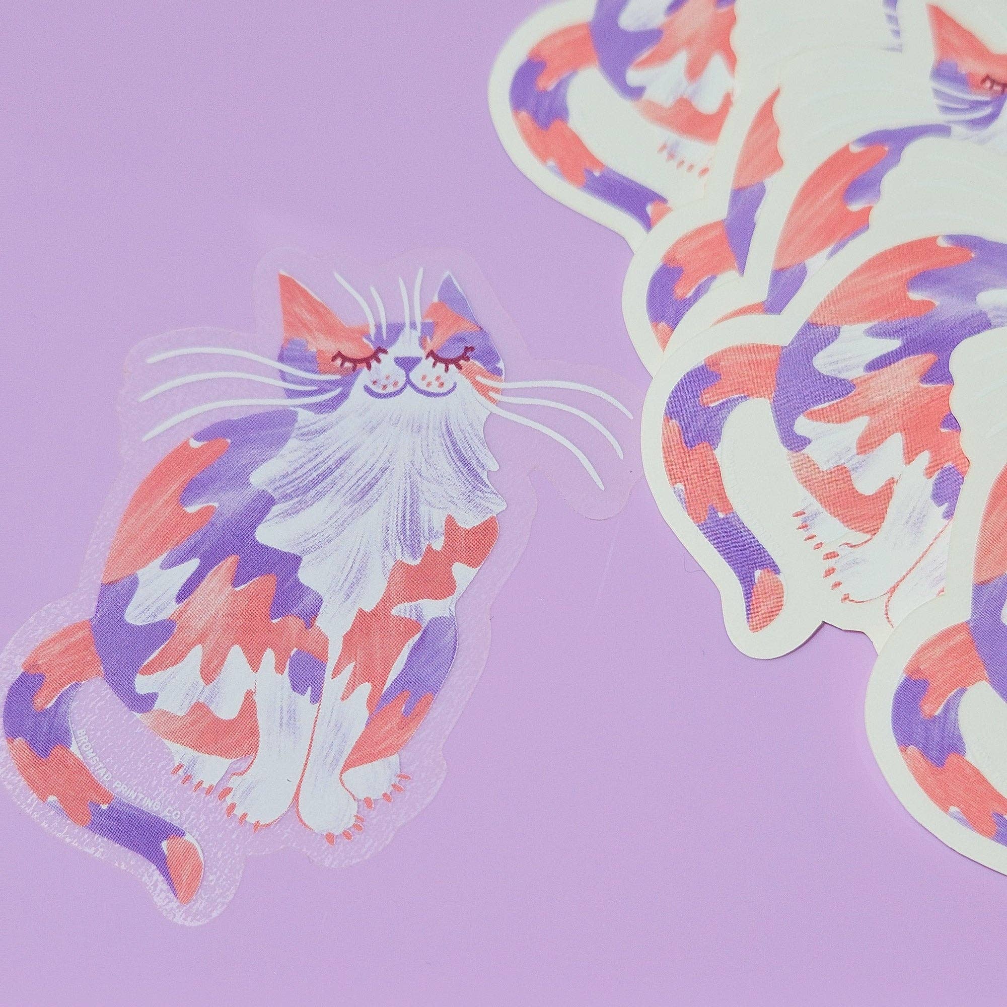 Colorful cat-shaped stickers on a purple background