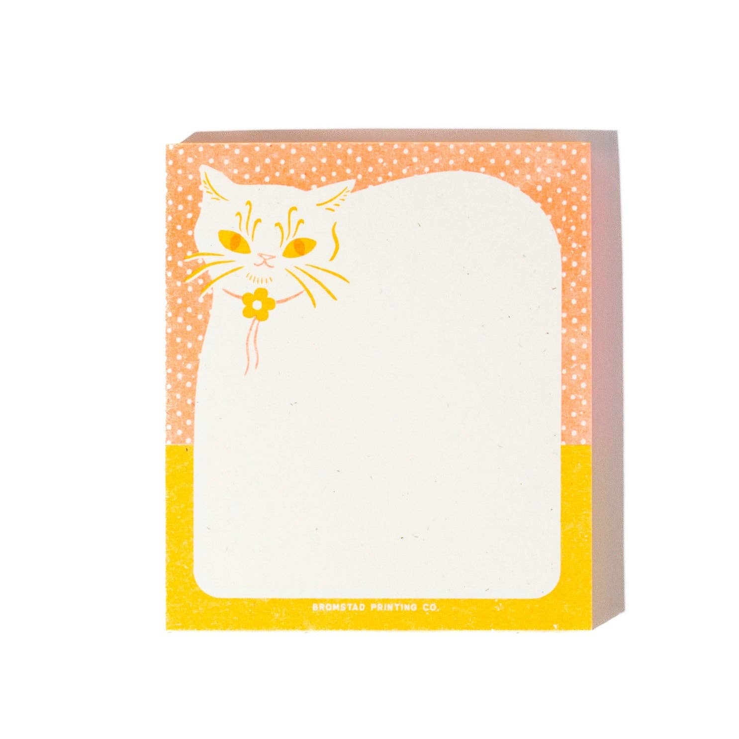 A square sticky note pad with a whimsical cat illustration. The top border is peach-orange with white polka dots and features a white cat face with yellow eyes and whiskers holding a small yellow flower.
