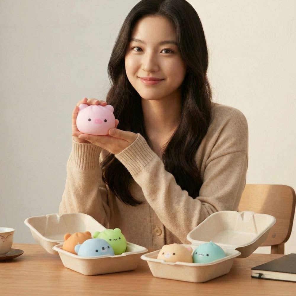 Woman holding a pink piggy bank with toy figures in the background