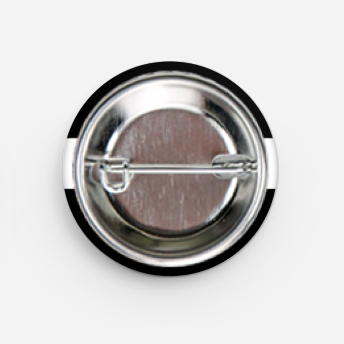 Round metal badge with a black rim on a white background