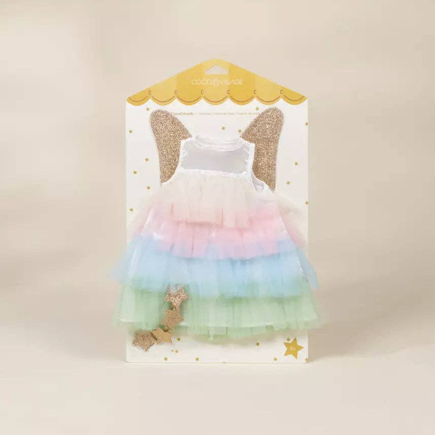 Pastel rainbow dress with angel wings on a beige background