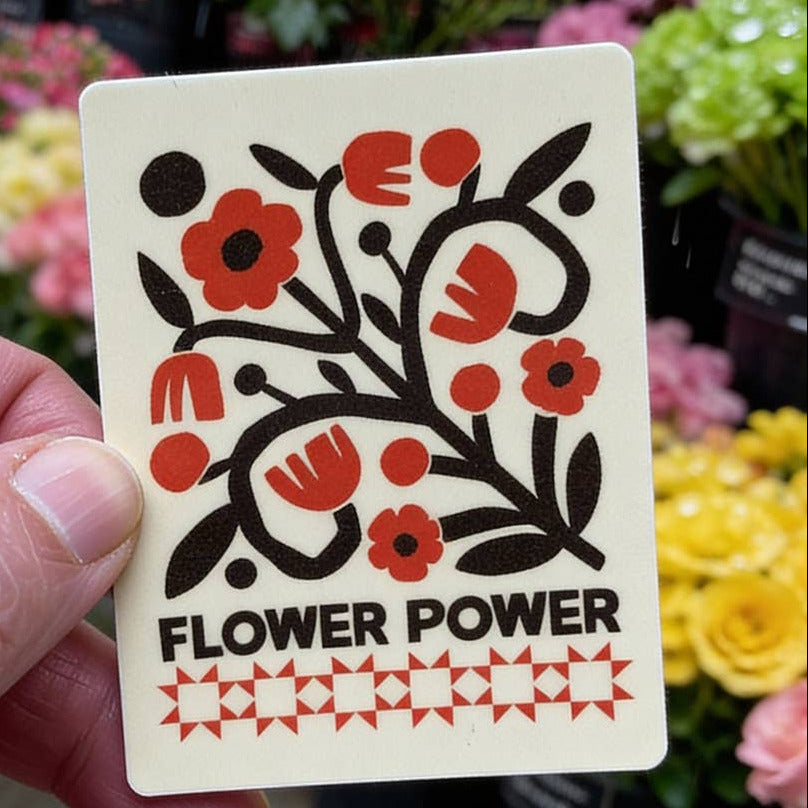 Card with floral design and 'Flower Power' text held in front of a floral background