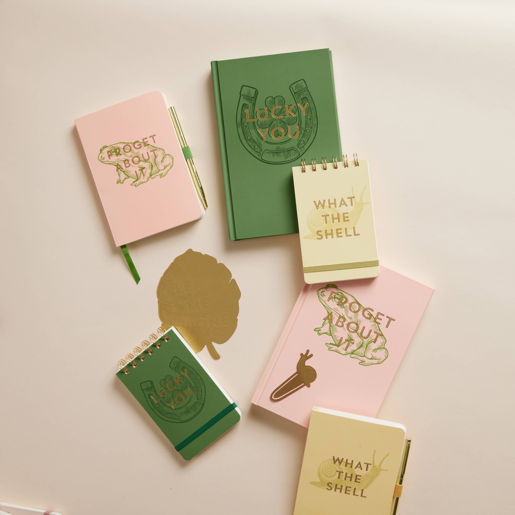 Set of small notebooks with various designs and text on a light background