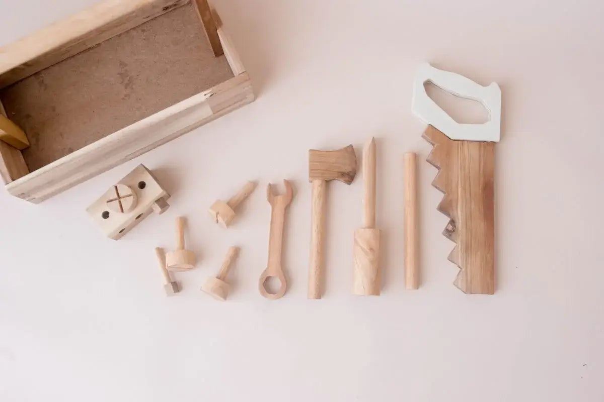 Set of wooden tools and a box on a light surface