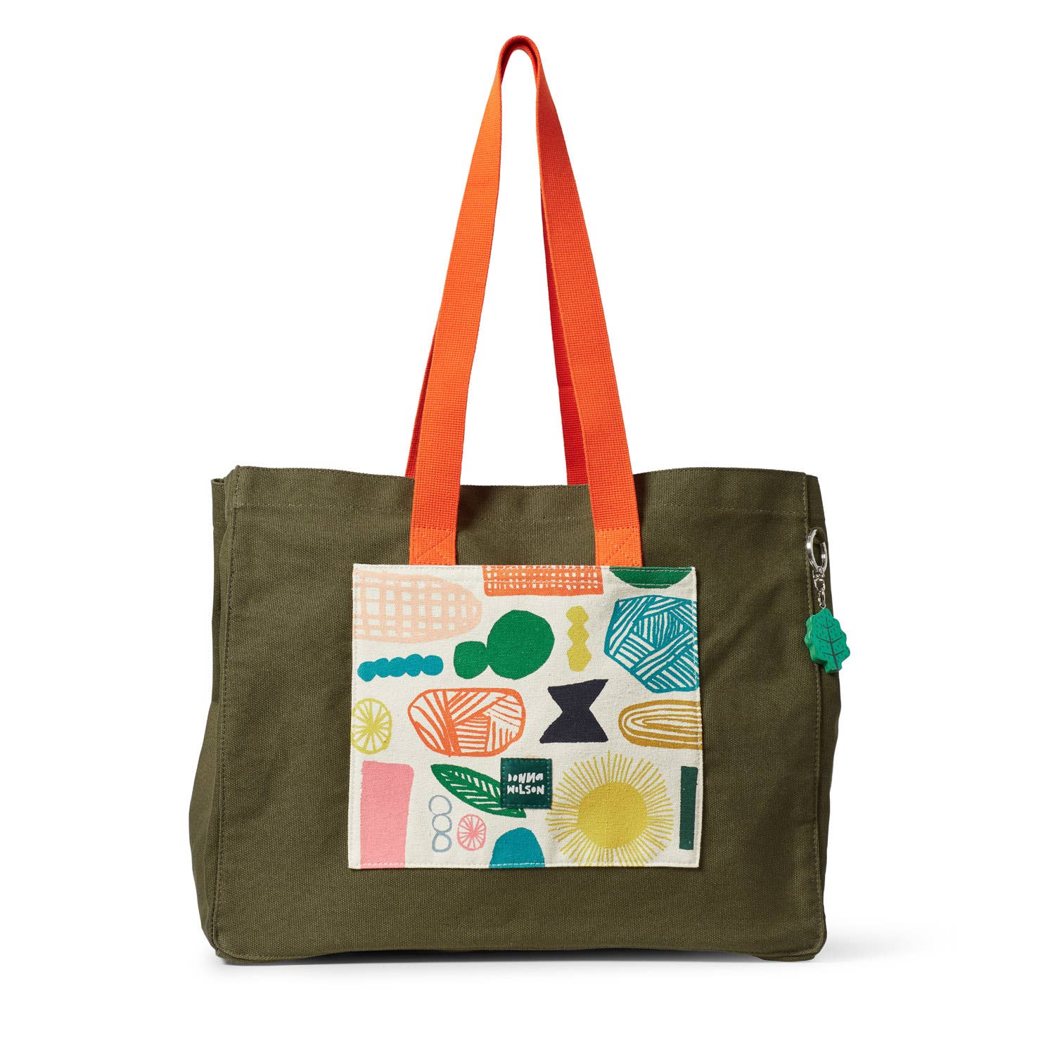 Green tote bag with colorful geometric pattern and orange handles on a white background
