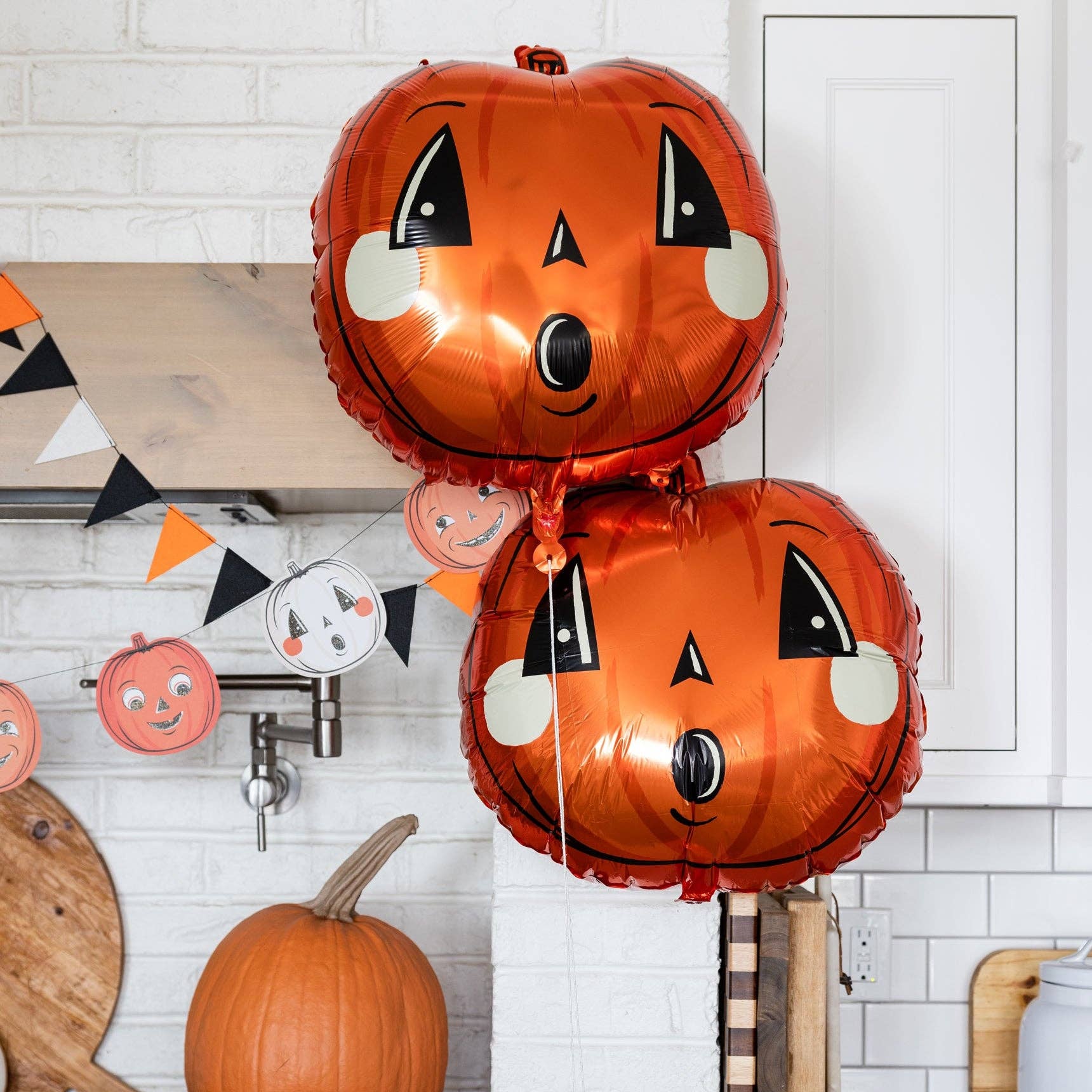 Halloween-themed balloons and decorations in a kitchen setting