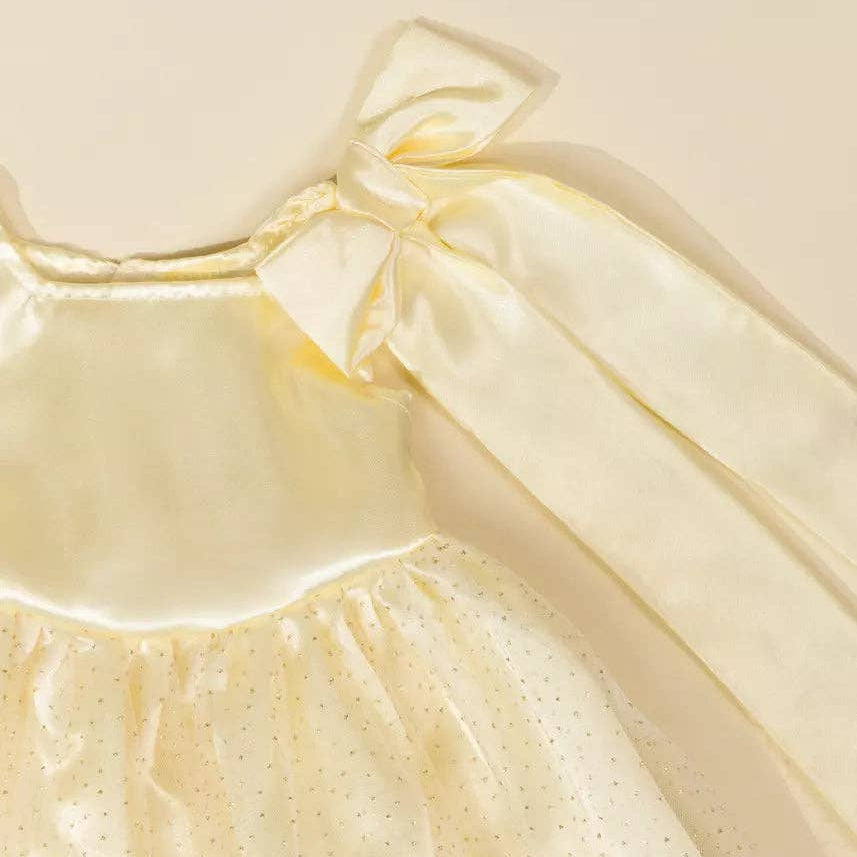 Beige dress with a bow detail on a beige background