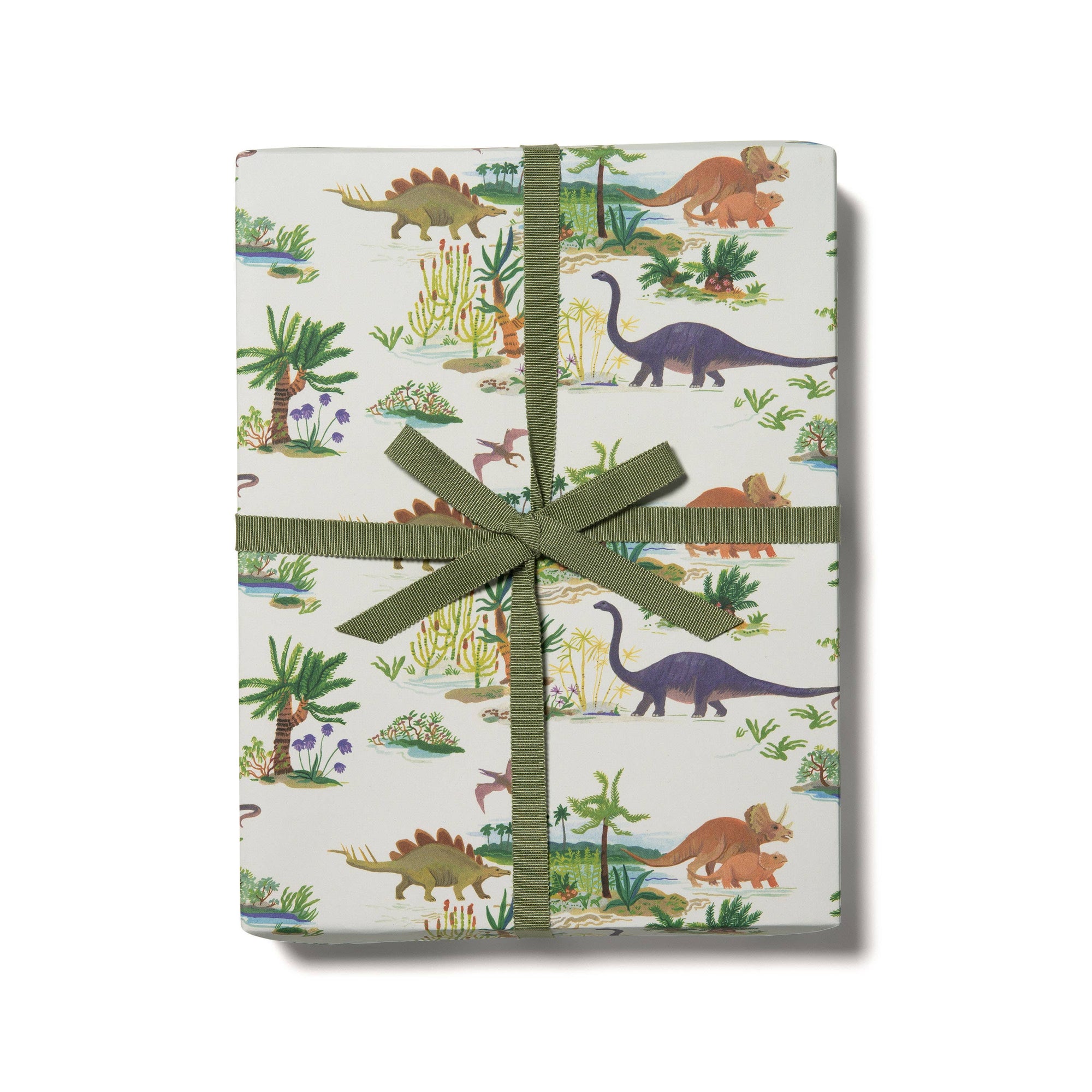 Gift box with dinosaur pattern and green ribbon on a white background