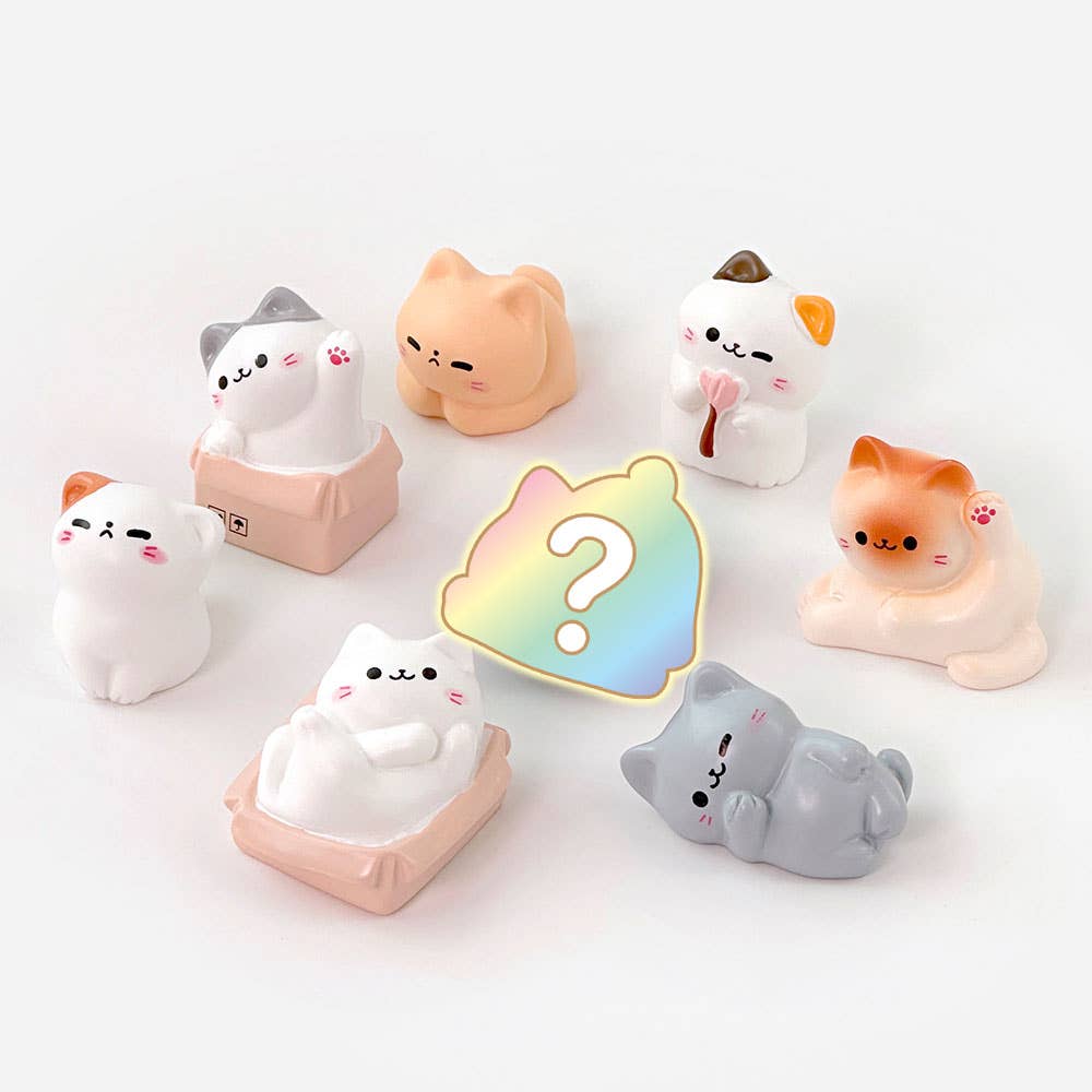 Set of cute cat-shaped squishies with a colorful question mark icon on a white background